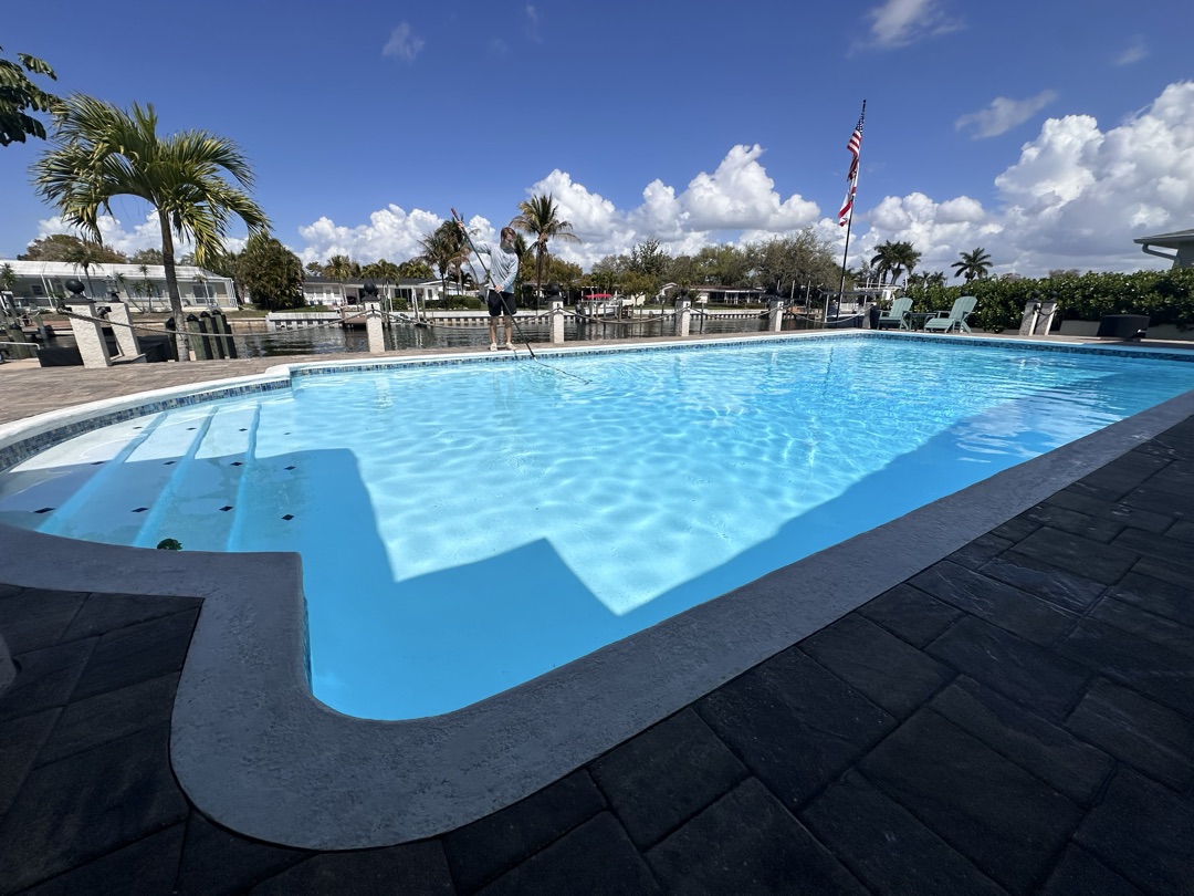 Brilliant blue pool with waterway view in Seminole FL — Sunshine Pool Group weekly pool service