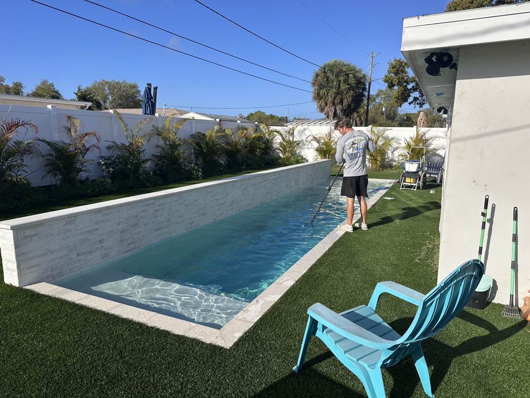 Sunshine Pool Group technician servicing a residential pool in St. Petersburg, FL